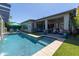Beautiful swimming pool with spa, adjoining back patio, and lush landscaping at 5515 S Caisson Way, Mesa, AZ 85212