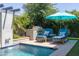 Gorgeous swimming pool featuring a BBQ, waterfall, and stylish lounge chairs at 5515 S Caisson Way, Mesa, AZ 85212
