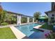 Sparkling swimming pool with built-in fountains and pergola providing shade and elegance at 5515 S Caisson Way, Mesa, AZ 85212