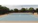 A well-maintained tennis court with neat net is surrounded by fencing and lush greenery, providing a private playing space at 5515 S Caisson Way, Mesa, AZ 85212