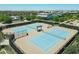 Aerial view features two blue tennis courts with a pergola in the middle of the community at 5515 S Caisson Way, Mesa, AZ 85212