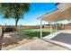 Backyard showcasing a covered patio, lush lawn, and mature landscaping at 640 S 34Th St, Mesa, AZ 85204