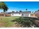 Large backyard featuring well-maintained grass, mature trees, and a block fence at 640 S 34Th St, Mesa, AZ 85204