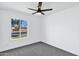 Bright bedroom featuring a ceiling fan, window with a view, and plush carpeting at 640 S 34Th St, Mesa, AZ 85204