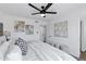 Bright bedroom featuring a ceiling fan, plush bedding, and modern artwork at 640 S 34Th St, Mesa, AZ 85204