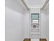 Spacious walk-in closet with built-in shelving and hardwood floors at 640 S 34Th St, Mesa, AZ 85204