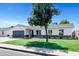 Charming single-story home features a well-manicured lawn, a grey garage door, and a brick pillar entrance at 640 S 34Th St, Mesa, AZ 85204