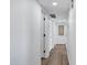 Clean hallway with wood-style flooring, white walls, closet doors, and recessed lighting at 640 S 34Th St, Mesa, AZ 85204