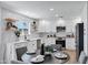 Contemporary kitchen with white cabinetry, stainless steel appliances, and stylish shelving at 640 S 34Th St, Mesa, AZ 85204