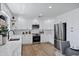 Bright kitchen features white cabinets, stainless steel appliances, marble countertops, and wood-style flooring at 640 S 34Th St, Mesa, AZ 85204