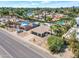 Inviting aerial shot of a well-maintained home with solar panels, set in a desirable neighborhood with mature trees at 6620 E Paradise Ln, Scottsdale, AZ 85254
