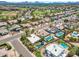 Community aerial view featuring residential streets, green spaces, and several backyard pools at 6620 E Paradise Ln, Scottsdale, AZ 85254