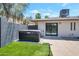 Private backyard oasis featuring a hot tub, artificial grass, desert landscaping, and serene outdoor living at 6620 E Paradise Ln, Scottsdale, AZ 85254