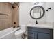 Renovated bathroom features tub with shower, modern fixtures, and stylish vanity at 6620 E Paradise Ln, Scottsdale, AZ 85254