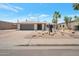 Charming single-story home with desert landscaping, two-car garage, and inviting entrance at 6620 E Paradise Ln, Scottsdale, AZ 85254