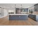 Modern kitchen boasts a large island, gray cabinets, stainless appliances, and ample storage at 6620 E Paradise Ln, Scottsdale, AZ 85254