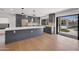 Contemporary kitchen with gray cabinets, quartz countertops, stainless appliances, and island at 6620 E Paradise Ln, Scottsdale, AZ 85254