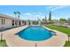 Inviting backyard with a sparkling pool, lush artificial turf, and a modern pergola, perfect for relaxation and entertainment at 6620 E Paradise Ln, Scottsdale, AZ 85254