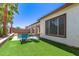 Backyard featuring a pool and lush artificial grass, creating a perfect outdoor oasis at 6805 S Sapphire Way, Chandler, AZ 85249