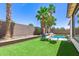 Backyard featuring a refreshing pool and lush artificial grass, perfect for relaxation and outdoor entertainment at 6805 S Sapphire Way, Chandler, AZ 85249