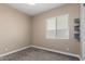 Bedroom featuring plush carpet, neutral walls, window with blinds, and built-in shelves at 6805 S Sapphire Way, Chandler, AZ 85249