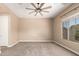 Bedroom features plush carpeting, a ceiling fan, bright windows, and a neutral color palette at 6805 S Sapphire Way, Chandler, AZ 85249