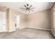 Neutral bedroom features plush carpeting, a ceiling fan, bright windows, and a closet at 6805 S Sapphire Way, Chandler, AZ 85249