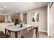 Dining area with a marble table, seating for six, and adjacent kitchen at 6805 S Sapphire Way, Chandler, AZ 85249