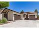 Home with a desert themed yard leading to a two car garage and an additional single car garage at 6805 S Sapphire Way, Chandler, AZ 85249