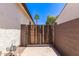 Wooden gate leads to a block-walled side yard, ensuring privacy and security at 6805 S Sapphire Way, Chandler, AZ 85249