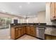 Open kitchen showcases granite countertops, stainless steel dishwasher, wood cabinets, and a view of the sparkling pool at 6805 S Sapphire Way, Chandler, AZ 85249