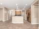 Open-concept living space with a kitchen island and tile flooring, perfect for modern living at 6805 S Sapphire Way, Chandler, AZ 85249
