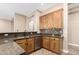 Charming kitchen features wood cabinets, granite countertops, mosaic tile backsplash, and stainless steel dishwasher at 6805 S Sapphire Way, Chandler, AZ 85249