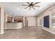 Open-concept living area featuring tile flooring, a ceiling fan, and an open view of the kitchen at 6805 S Sapphire Way, Chandler, AZ 85249