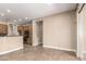 Neutral living area with tile floors offers a kitchen view, natural light, and an airy feel at 6805 S Sapphire Way, Chandler, AZ 85249