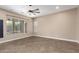 A bright and airy living space with neutral paint, tiled floors, ceiling fan, and natural light at 6805 S Sapphire Way, Chandler, AZ 85249