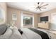 Bedroom with a large window overlooking the backyard, a ceiling fan, and a neutral color scheme at 6805 S Sapphire Way, Chandler, AZ 85249