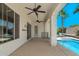 Covered outdoor patio overlooking a pool, with ceiling fans and an outdoor seating area at 6805 S Sapphire Way, Chandler, AZ 85249