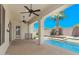 Covered outdoor patio overlooking a pool, with ceiling fans and desert landscaping at 6805 S Sapphire Way, Chandler, AZ 85249