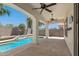 Covered patio area overlooking the backyard and pool, equipped with fans for comfort at 6805 S Sapphire Way, Chandler, AZ 85249