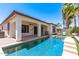 A beautiful pool is the centerpiece of the backyard, surrounded by an extended patio and lush, well-maintained artificial grass at 6805 S Sapphire Way, Chandler, AZ 85249