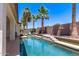 Sparkling pool featuring palm trees and a tanning ledge with steps for relaxing and enjoying the desert climate at 6805 S Sapphire Way, Chandler, AZ 85249