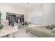 Bright bedroom features a ceiling fan, closet, and desk with a window view at 6958 W Morning Dove Dr, Glendale, AZ 85308