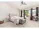 Bright bedroom featuring a cozy bed, neutral decor, and a bright backyard view at 6958 W Morning Dove Dr, Glendale, AZ 85308
