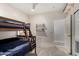 Bedroom with a wooden bunk bed and neutral decor offers a comfortable and functional layout at 6958 W Morning Dove Dr, Glendale, AZ 85308