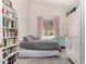 Bright bedroom features a comfortable bed, built-in bookcase, and ample natural light at 6958 W Morning Dove Dr, Glendale, AZ 85308