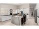 Bright kitchen with white cabinetry, stainless appliances, and an oversized island at 6958 W Morning Dove Dr, Glendale, AZ 85308