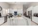 Modern kitchen featuring an island with a stone countertop, white cabinets and tiled backsplash at 6958 W Morning Dove Dr, Glendale, AZ 85308
