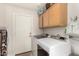 Well-equipped laundry room features a washer, dryer, storage cabinets, and ample space at 6958 W Morning Dove Dr, Glendale, AZ 85308