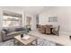 Stylish living room featuring a sofa, dining table, and bright interior at 6958 W Morning Dove Dr, Glendale, AZ 85308